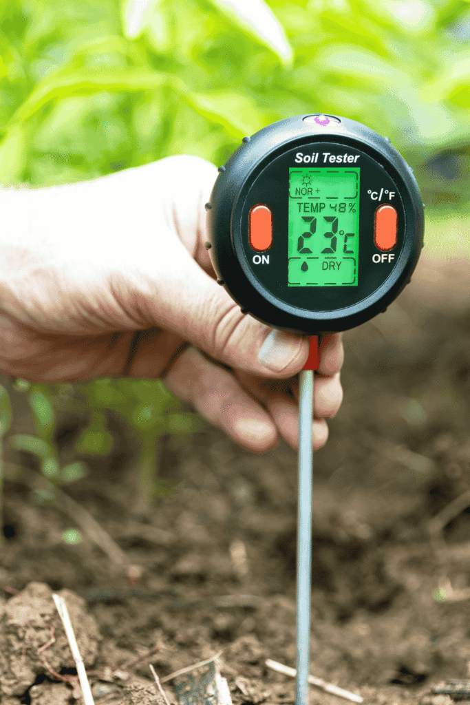 Soil testing machine analyzing garden soil for optimal lawn care cost and beginner-friendly gardening tips.